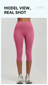 Close-up of pink high-waisted yoga capris with peach lift seam and matte elastic fabric