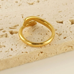Fashion 18k gold plated stainless steel hug ring with curved design on travertine