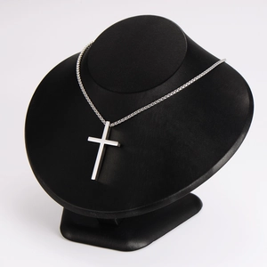 Minimalist silver stainless steel cross pendant necklace displayed on a black neck bust