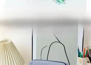 Close-up of blue seersucker striped pencil case on a cozy desk with stationery