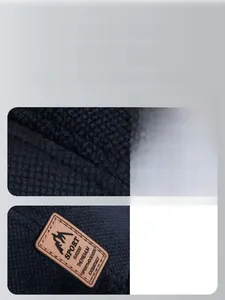 Detail of dark blue thermal beanie featuring quilted texture and leather mountain sport logo