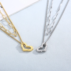 Double-layered gold and silver necklaces with textured heart pendants in vintage style