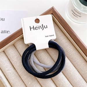Detail shot of black and grey high elasticity hair bands on a HenJu branded card
