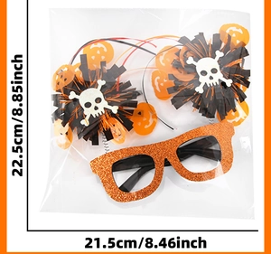 Close-up of Halloween tinsel glasses with skull and pumpkin decor in clear packaging