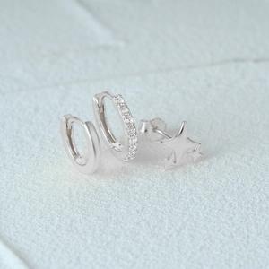 Detailed view of 925 sterling silver set featuring star studs and zircon hoop earrings