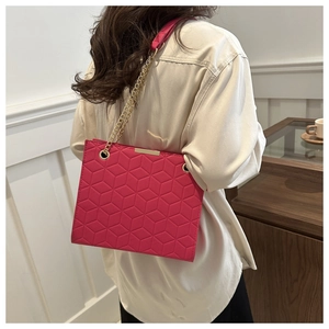 Hot pink quilted chain crossbody bag for women featuring geometric hexagonal patterns
