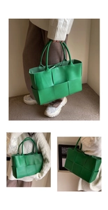 Detailed view of large green woven tote bag carried by model for casual styling