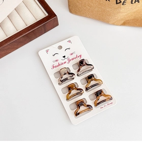 Detailed set of 6 mini leopard tortoise hair claws on a stylish cat display card