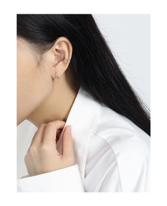 Close-up of minimalist S925 sterling silver olive bead earrings worn by a model