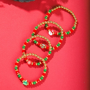 Detail of Christmas beaded bracelet set with Santa, tree, and snowflake charms