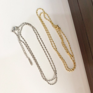 Detailed close-up of gold and silver stainless steel rice bead necklaces with lobster clasp