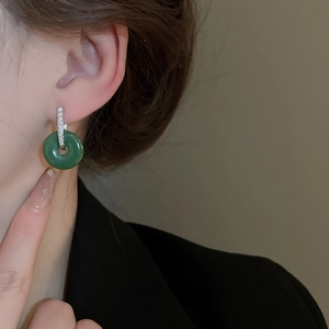 Detail of a New Chinese-style green jade ping'an buckle earring on a female model