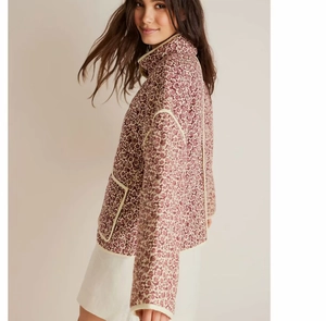 Detail of French vintage quilted jacket featuring burgundy floral print and long sleeves