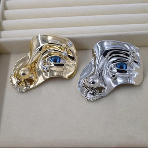 Artistic metal face brooches in gold and silver finish with blue eye details