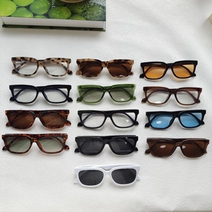 Flat lay of retro cat eye sunglasses in leopard, black, and green acetate frames
