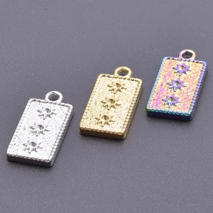 Detailed view of silver, gold, and rainbow stainless steel rectangular sunburst pendants