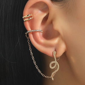 Detailed view of gold ear cuff set with snake stud, cubic zirconia, and link chain