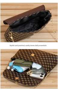 Detail view of small square bag interior with pearl chain and deep brown pattern