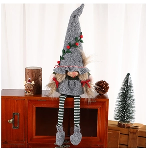 Weihnachtswichtel-Detail mit grauer Strickmütze, Streifenbeinen und roten Beeren