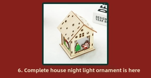 Detail of DIY glowing wooden Christmas house with snowman, star cutouts and warm lighting