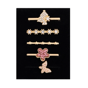 Detailed view of 5-piece gold watch band charms with snowflake and pearl butterfly