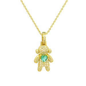 Detailed close-up of golden bear pendant necklace with sparkling zircons and green heart stone