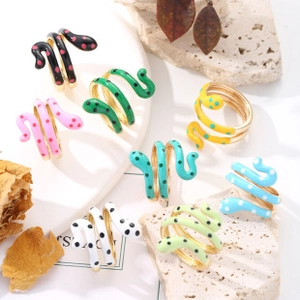 Detailed macro view of vibrant colorful snake rings with enamel polka dot patterns