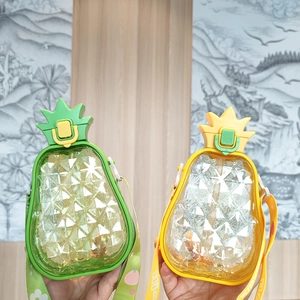 Detail of creative pineapple straw bottle with adjustable cartoon strap and textured body