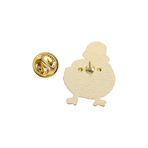 Detailed view of the gold metal badge back featuring a secure safety pin fastener