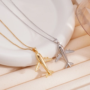 Minimalist airplane pendant necklace in gold and silver finish with zircon accents