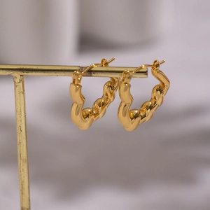 Classic 18K gold plated stainless steel twisted hoop earrings for women on a jewelry stand