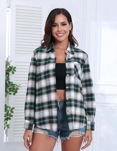 Detail of classic plaid shirt collar and button-down front with soft green fabric texture