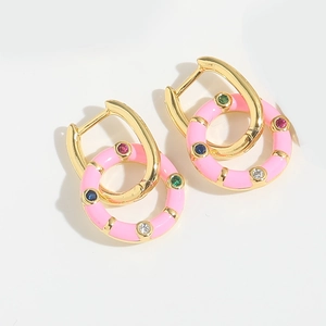 Macro detail of pink enamel hoop earrings with colorful zircon stones on gold base