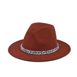 Detailed view of rust orange wide brim fedora hat with a gray marble acrylic chain link