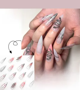 Detail of pink gradient stiletto press-on nails with silver flame and black snake design