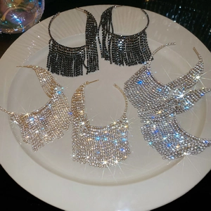 Detailed close-up of sparkling rhinestone tassel earrings in gold, silver, and black finishes