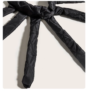 Detail of the black quilted heatless hair curler showing diamond texture and stitching