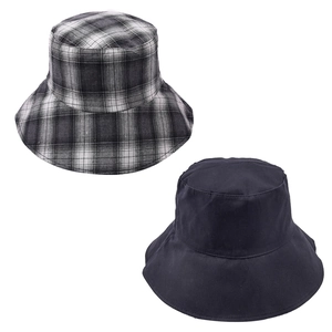 Detail shot of a reversible plaid and solid navy sun protection foldable bucket hat