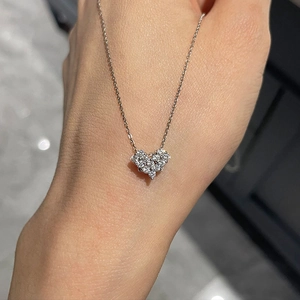 Detailed view of silver heart pendant necklace with shimmering round-cut crystals