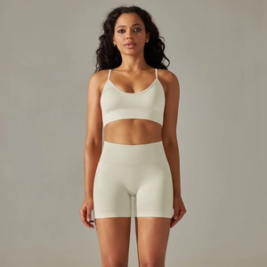 Front view of light green seamless yoga set with ribbed v-neck sports bra and high-waist shorts