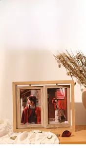Detail of a rotating wooden double-sided photo frame with natural grain and warm light