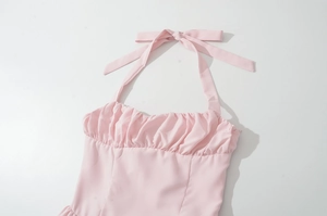 Detail of pink halter neck dress with front ruching and delicate tie strings