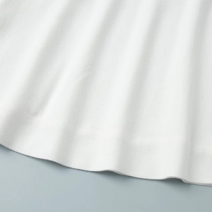 Close-up of white twill fabric texture with high-quality stitching on sleeveless top set