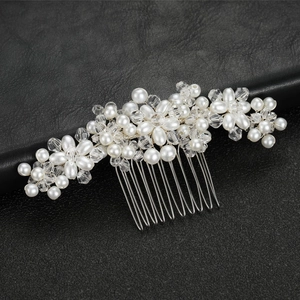Exquisite bridal hair comb with white pearls and clear crystals on a silver metal base