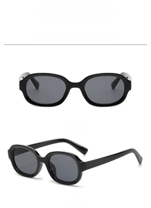 Front and 45-degree views of oval black fashion sunglasses with sleek black frames