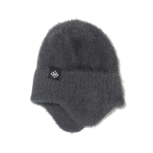 Close-up of thick grey winter knit hat with fluffy mink hair texture and ear flaps