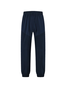 Detail of dark blue joggers with contrast pleated texture and elastic drawstring waist