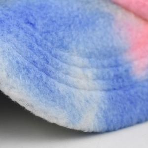 Detailed macro view of soft pink and blue gradient sherpa fleece fabric and stitching