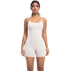Detail of cream white yoga romper showing U-neckline and slim fit elastic fabric