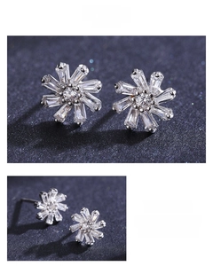 Macro view of flower-shaped S925 silver stud earrings with radiant cut zircon stones